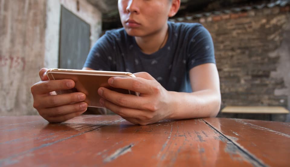 man playing phone
